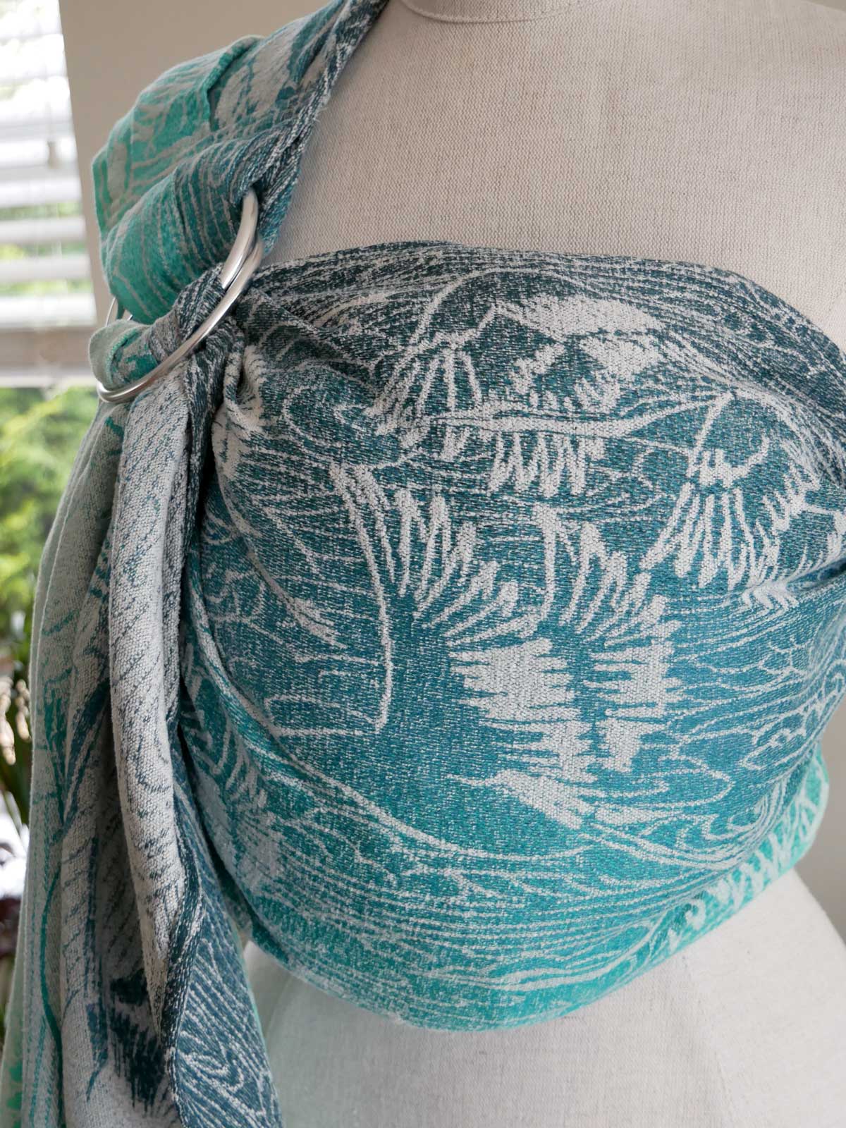 Teal and white patterned Cranes Pointbreak Ring Sling on a mannequin