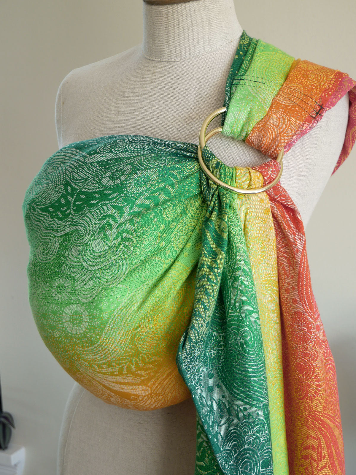 Mannequin wearing a colourful Marina Starburst Ring Sling with a gold ring, set against a neutral background.