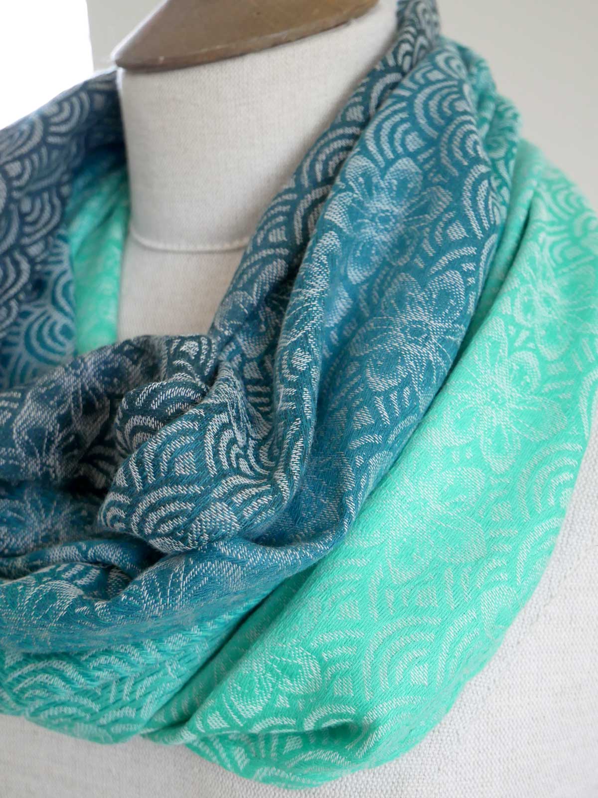 Teal patterned Sekaibloom Wave Cowl on a mannequin