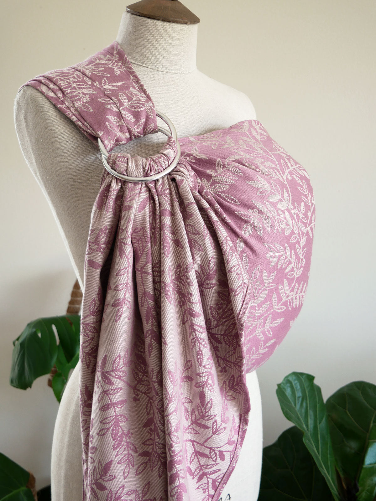 Dusty pink willow patterned ring sling on a mannequin against a white background