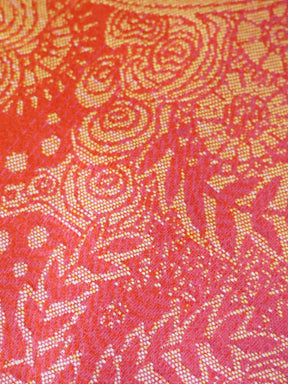 Close-up of a red fabric with gold intricate patterns