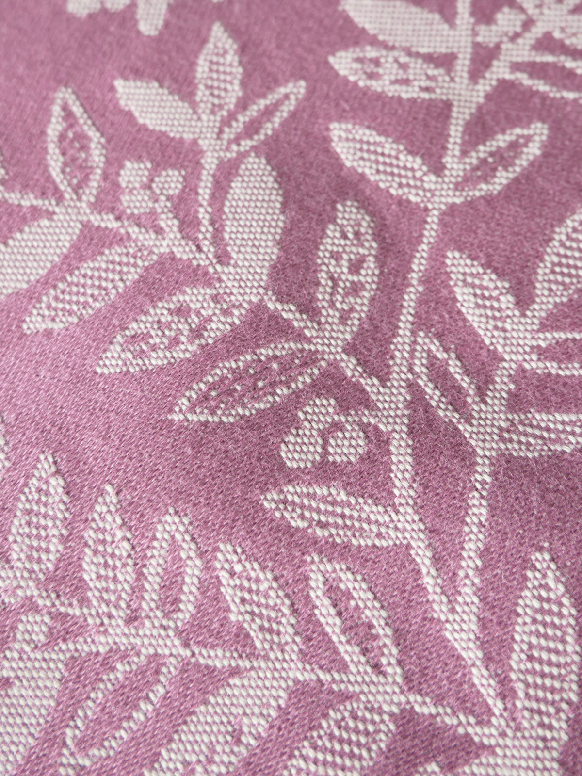 Close-up of a fabric with a leaf pattern on a pink background