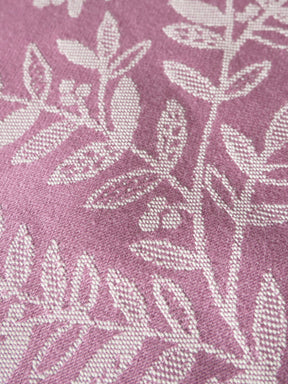 Close-up of a fabric with a leaf pattern on a pink background